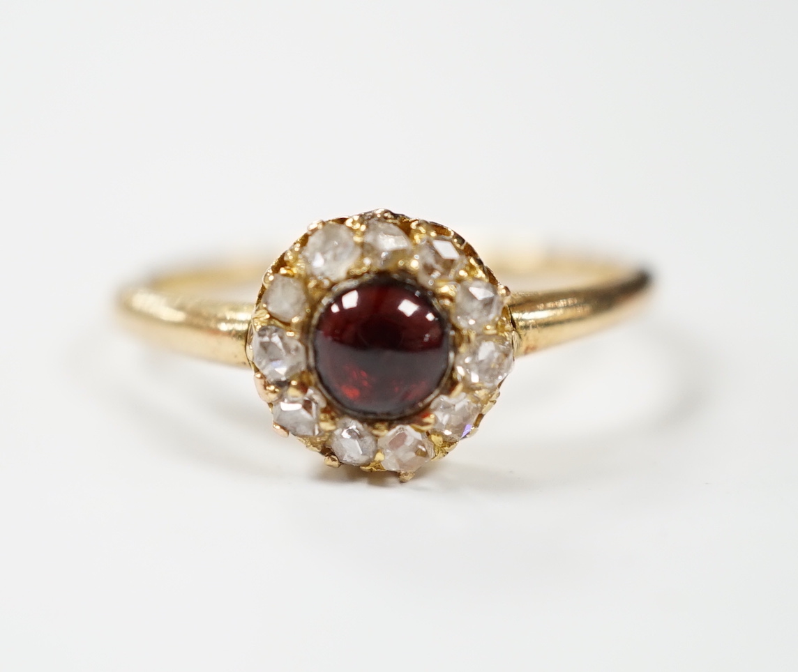 An 18ct, foil backed cabochon and diamond cluster set dress ring, by Annina Vogel, size M/N, gross weight 2.7 grams.